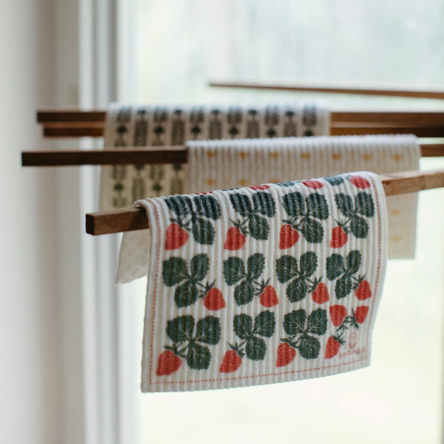 Oak wood towel drying rack holding Swedish Dishcloths