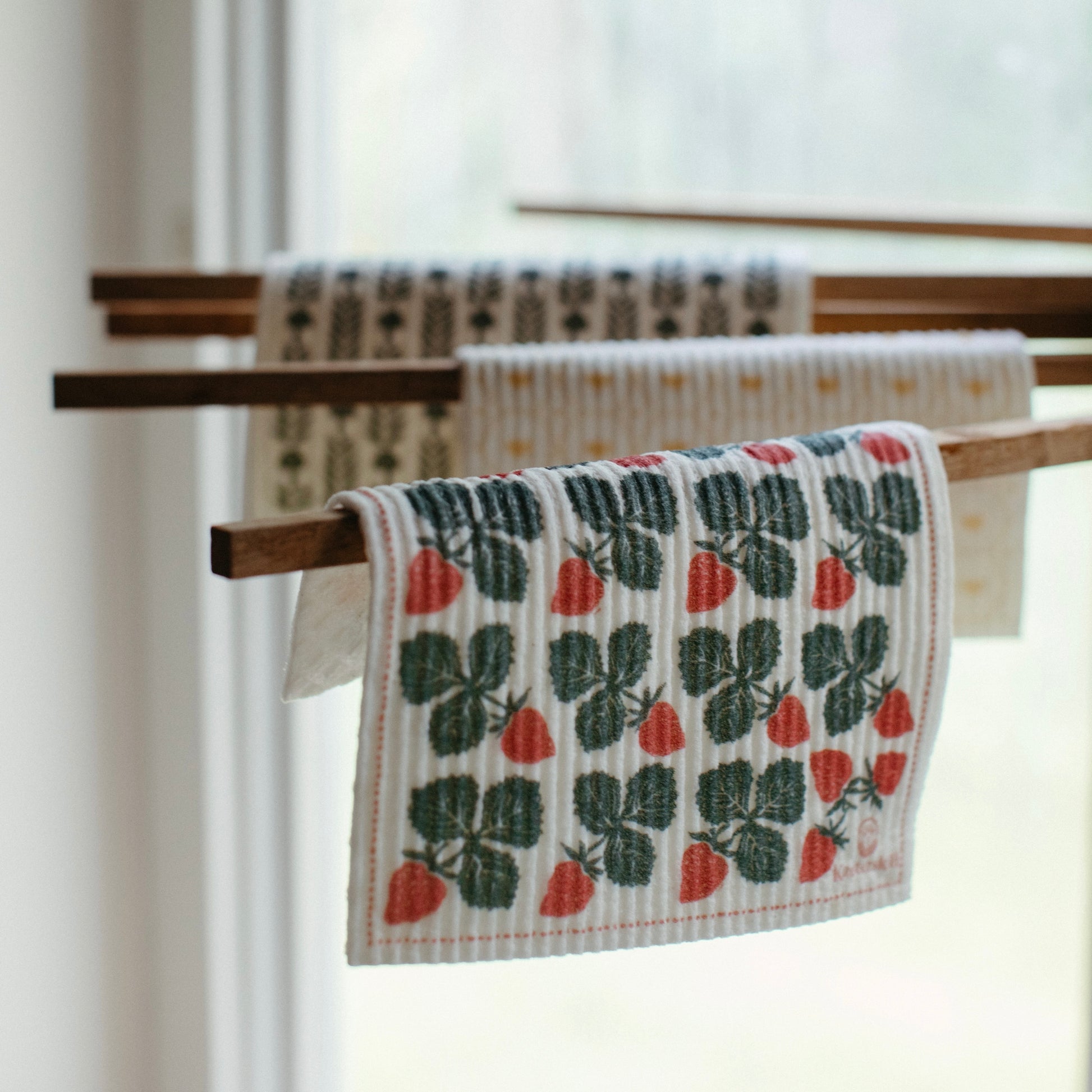 Oak wood towel drying rack holding Swedish Dishcloths