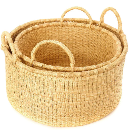 A smaller woven floor storage basket nesting in a larger one.