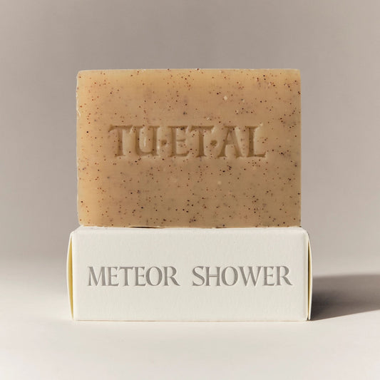 Bar of soap with 'TU.ET.AL' branding on a beige background