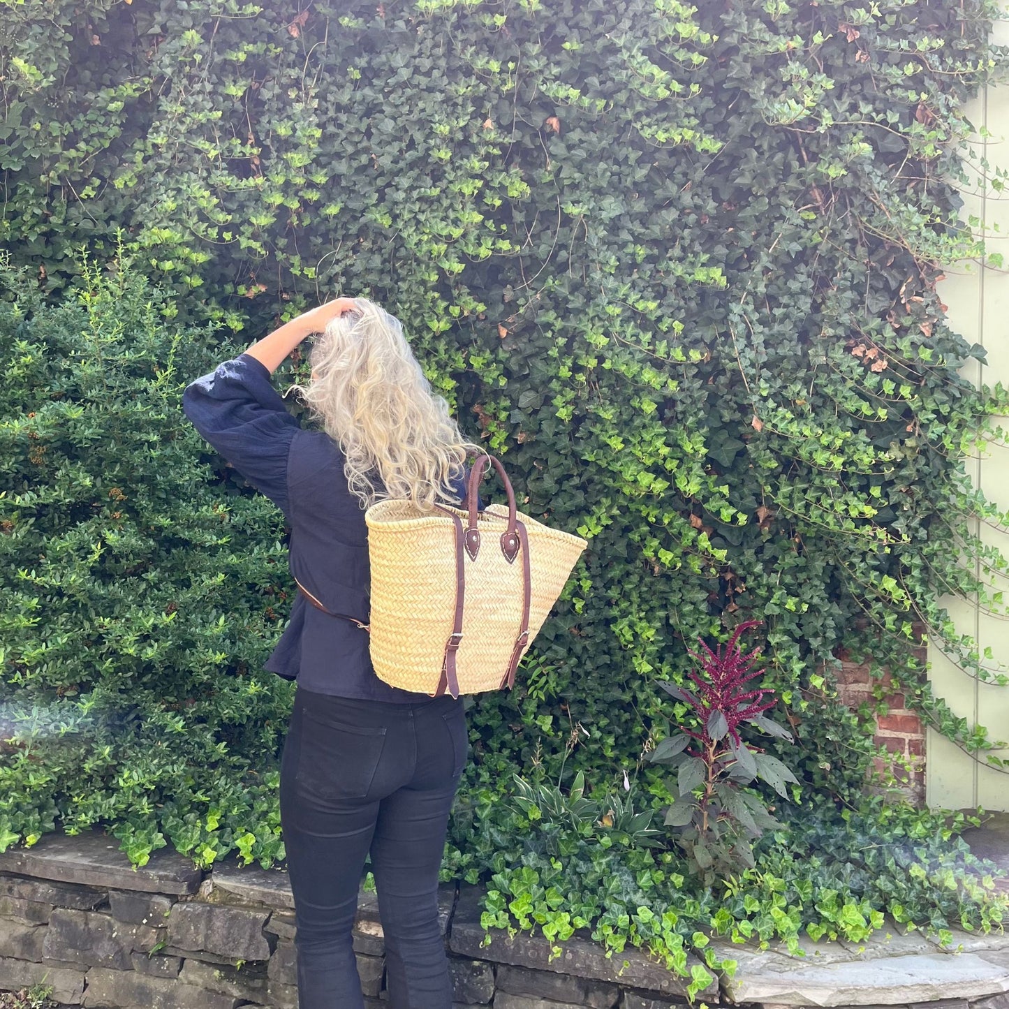 backpack basket on person's back in a garden