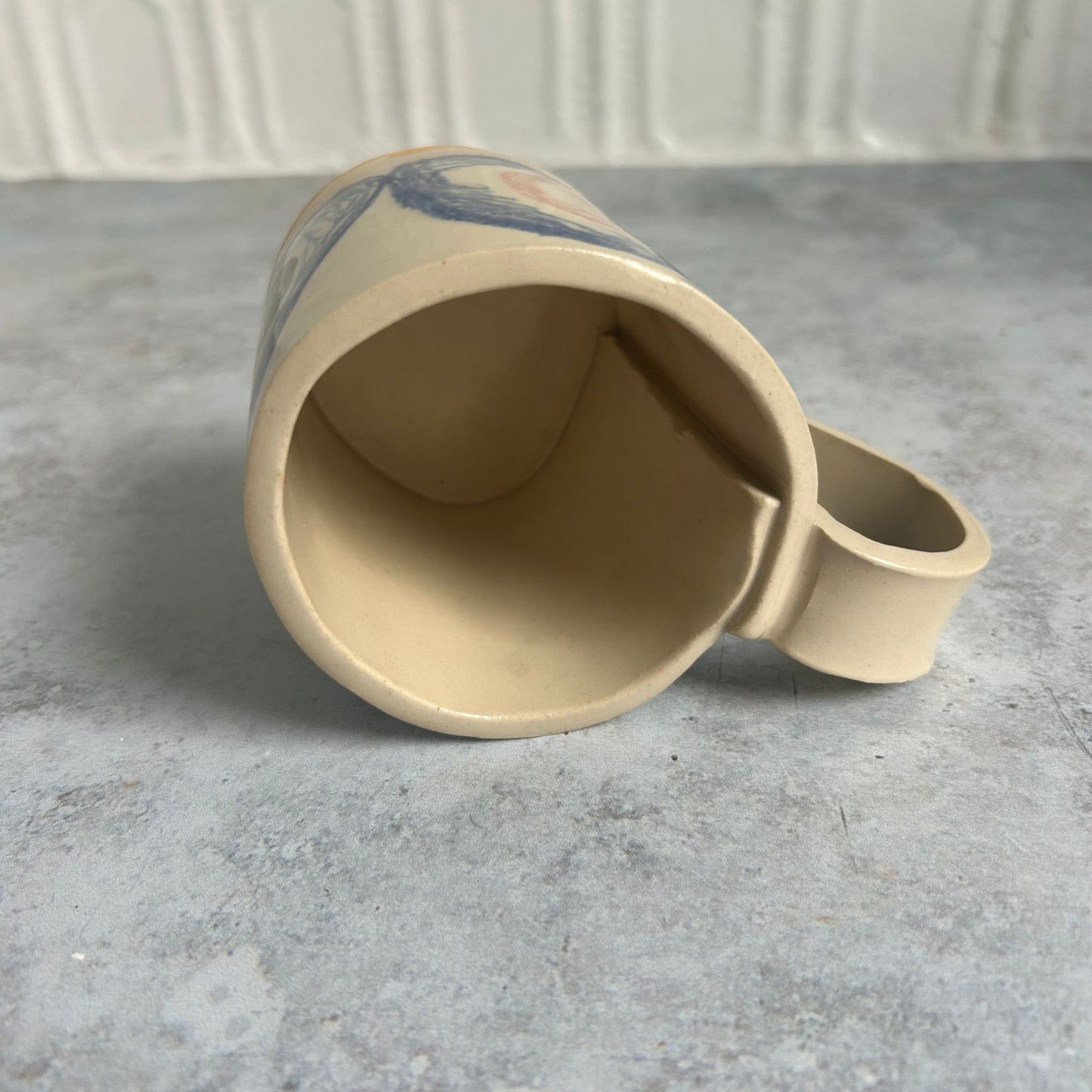 The inside of a white mug with blue circles.