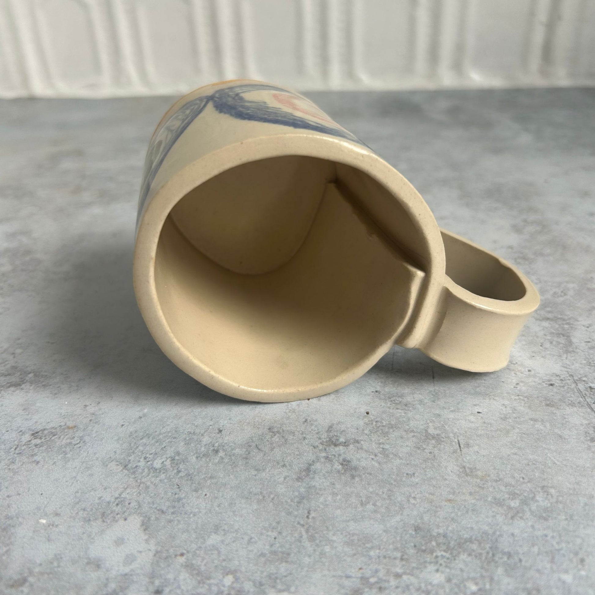 The inside of a white mug with blue circles.