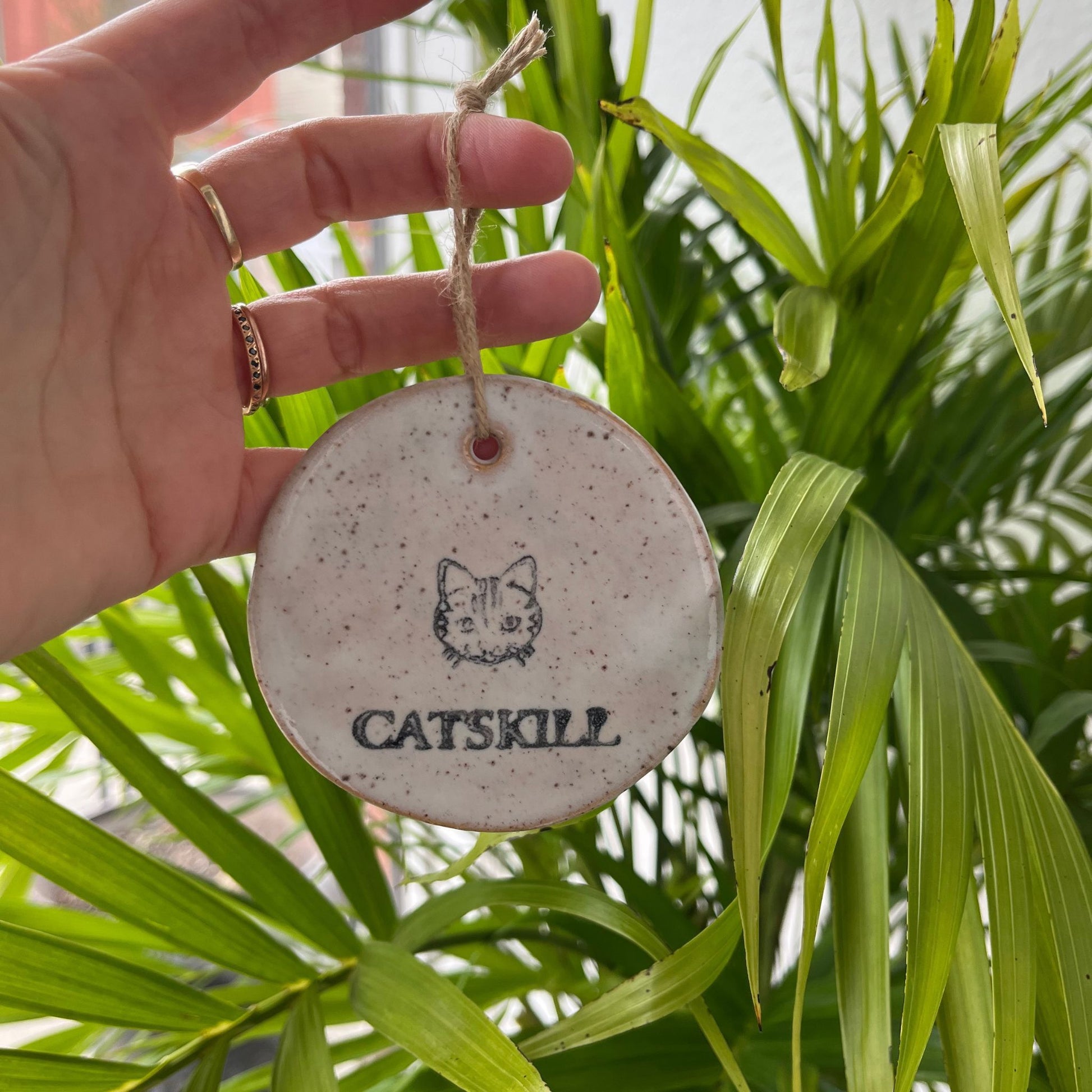 Ceramic Catskill Ornament with white speckle glaze. Approximately 3 inches wide