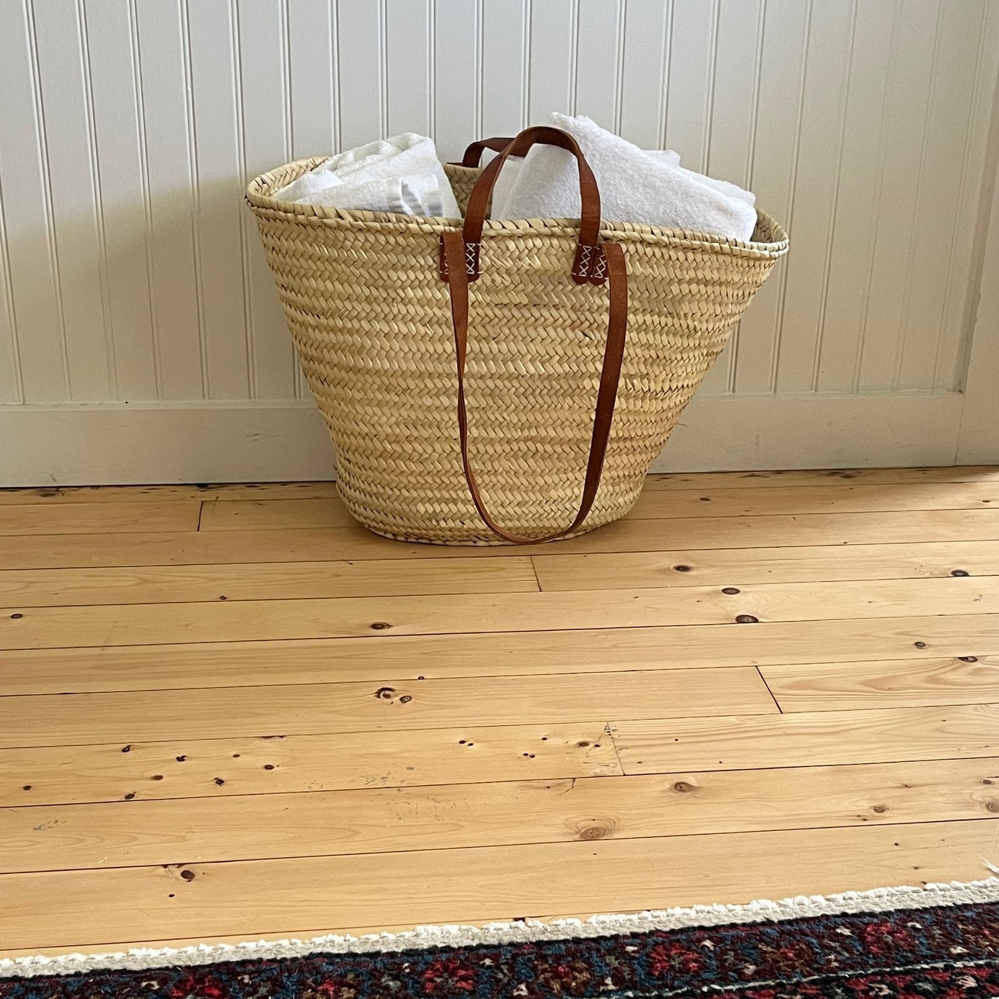 A french market tote filled with towels
