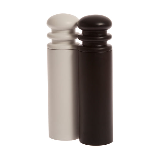 A black and a white salt or pepper mill grinder made of beechwood