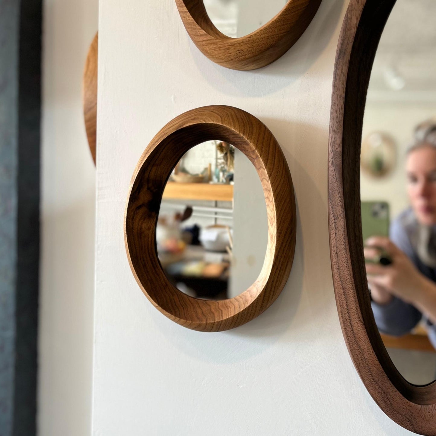 Small hand-carved butternut wood wall mirror with one-of-a-kind organic shape and curves