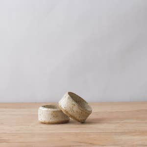 2 handmade ceramic napkin rings with a white speckled glaze