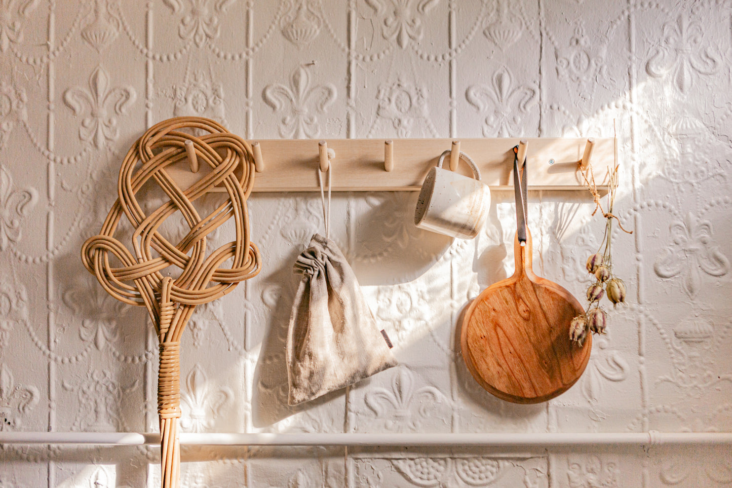 Example of Simple rail hanging rack with 7 peg hooks made of Birch wood