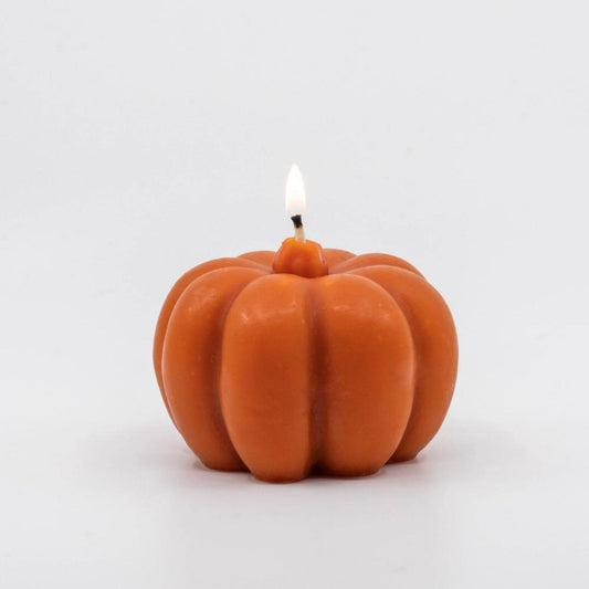 Hand-poured orange beeswax candle shaped like a pumpkin