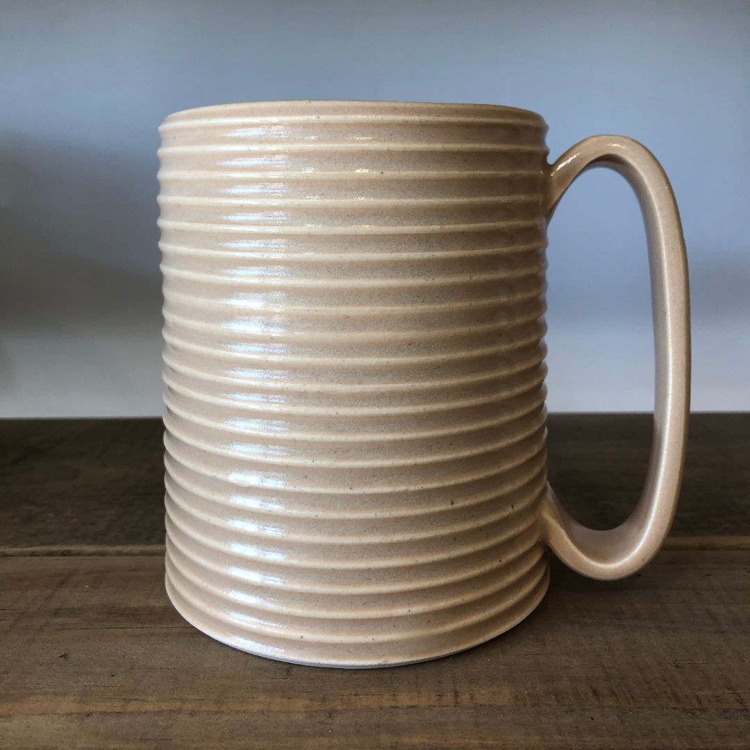 Oversized wheel-thrown ribbed ceramic stoneware mug with handmade glaze in ginger color