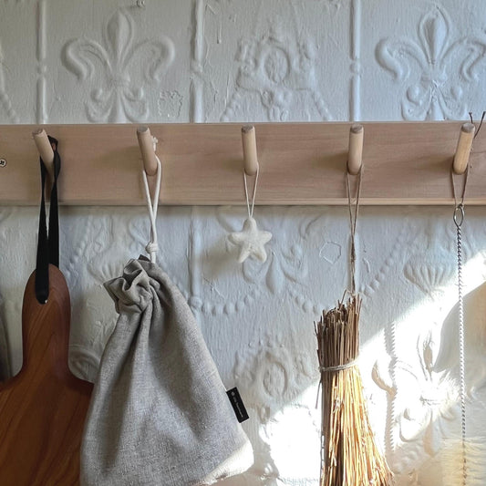 Handmade felted wool star hanging on wall hook rail