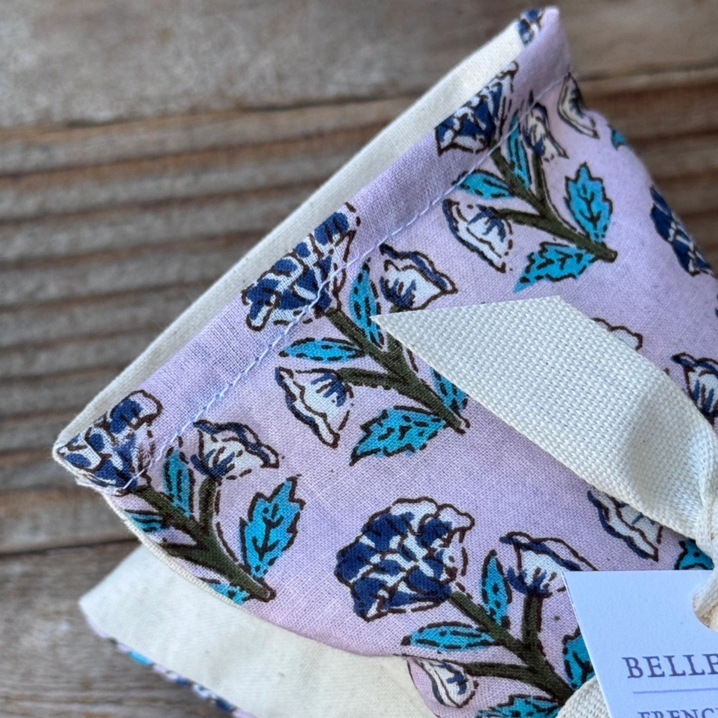 Floral patterned fabric pouch on a wooden surface