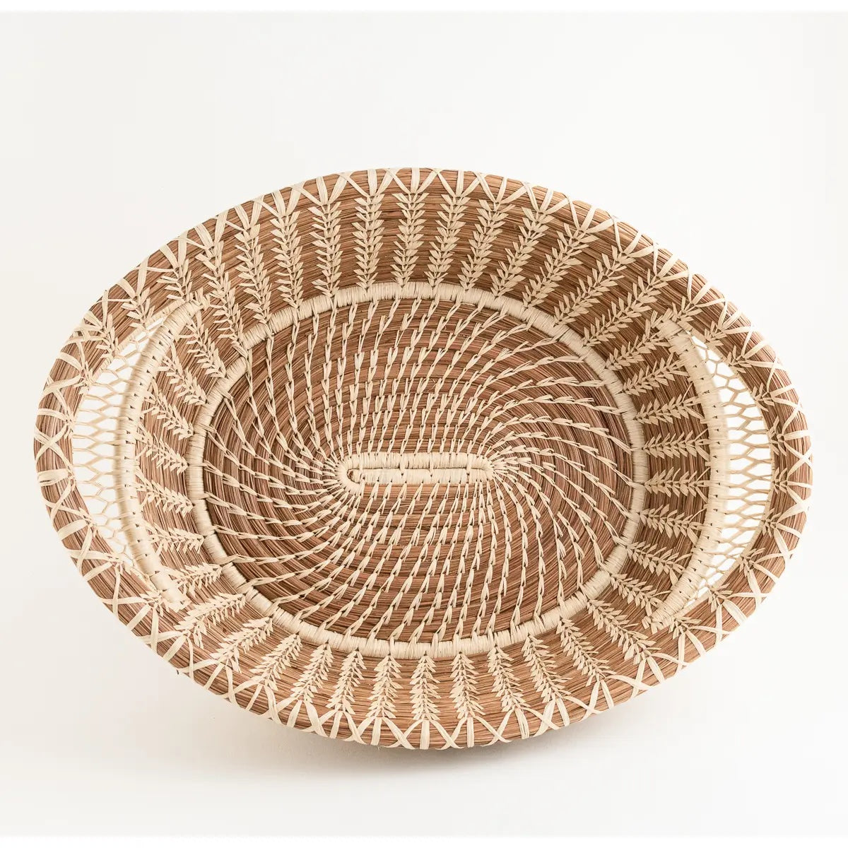 Large elegant pine needle basket features intricate lace-like raffia handles. Made of pine needles and pajón, a native grass found near Lake Atitlán in Guatemala. Handmade and fair trade.