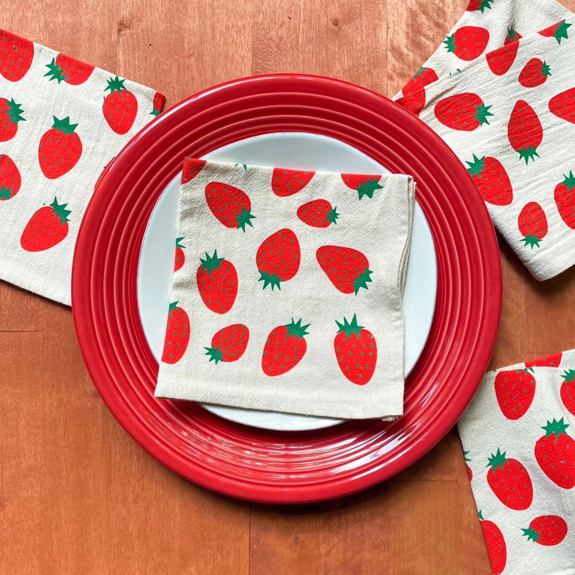 Set of kitchen towels with strawberry pattern on a red plate