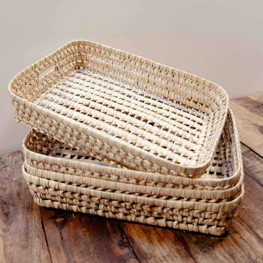Set of woven baskets on a wooden surface with a neutral background