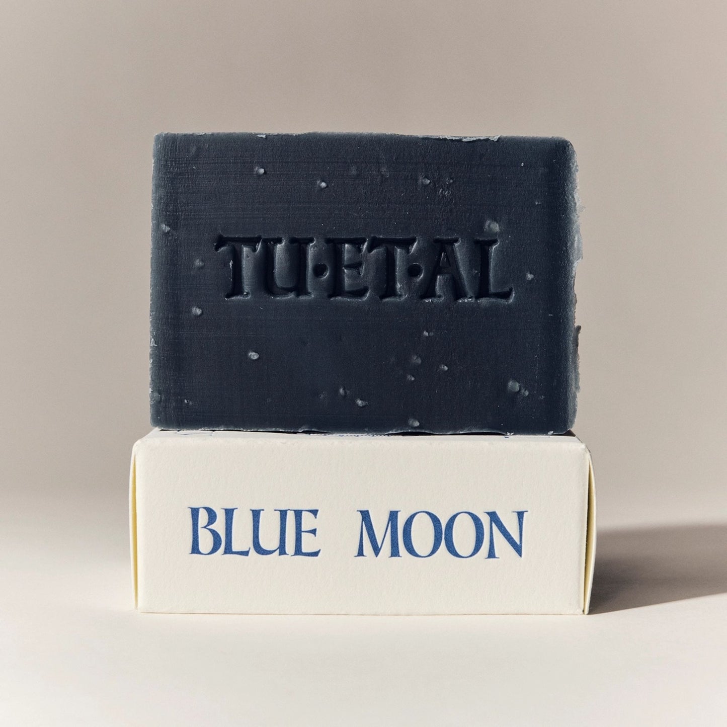 Bar of soap with 'TU-ET-AL' branding on a beige background