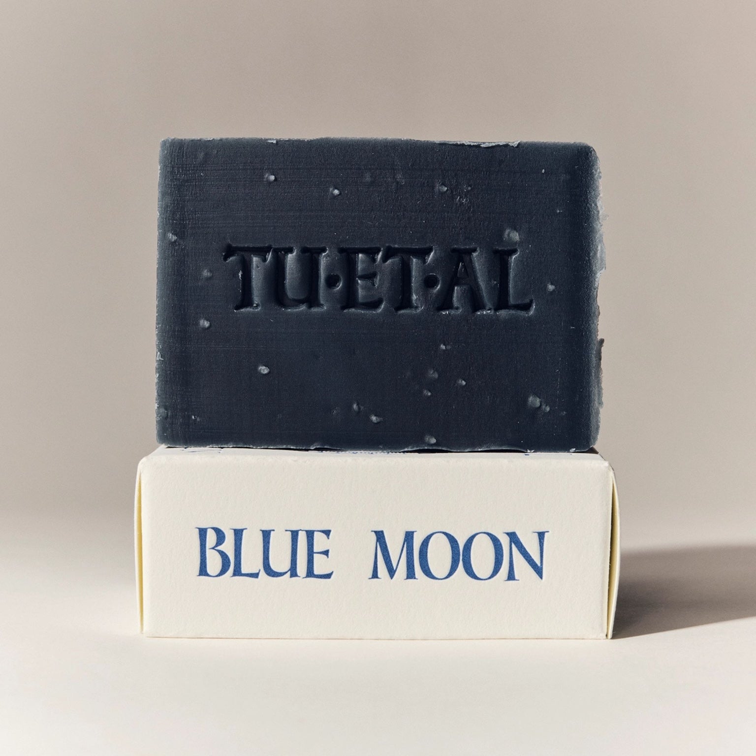 Bar of soap with 'TU-ET-AL' branding on a beige background