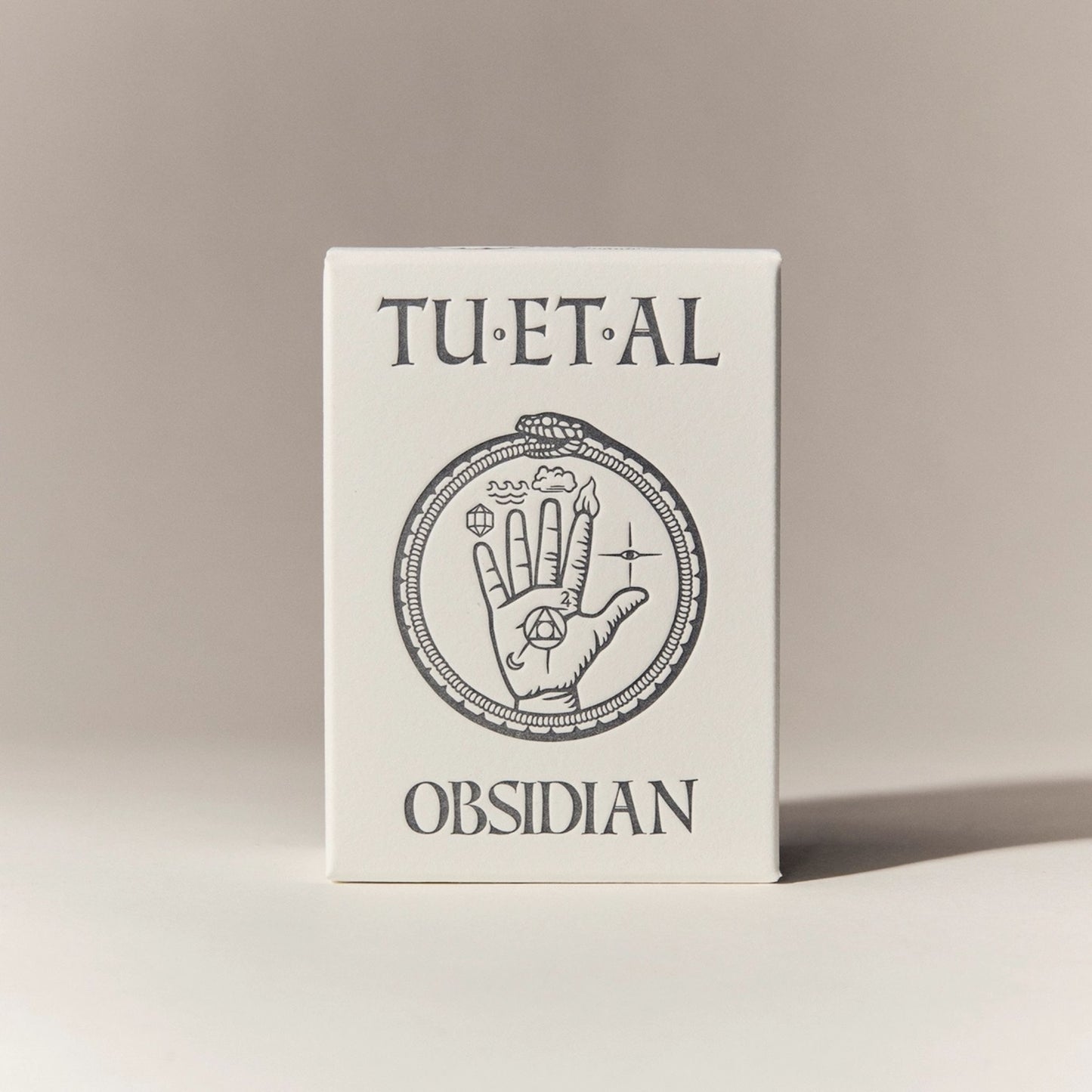 Box for soap with 'TU.ET.AL' and 'Obsidian' text on a beige background