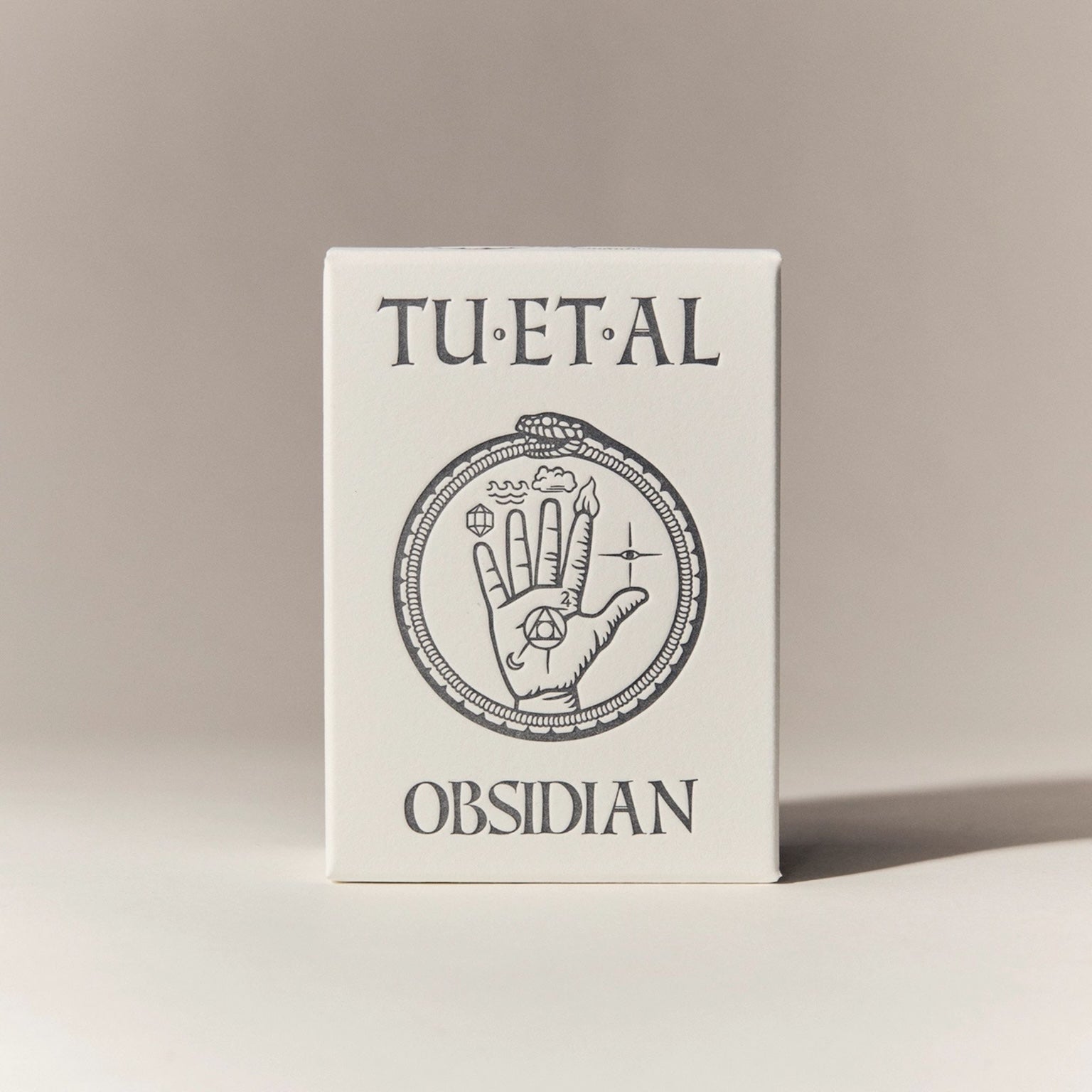 Box for soap with 'TU.ET.AL' and 'Obsidian' text on a beige background