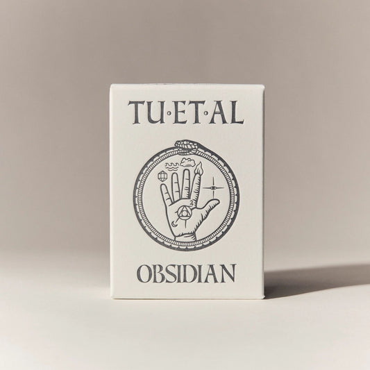 Box for soap with 'TU.ET.AL' and 'Obsidian' text on a beige background
