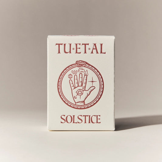 Box for soap bar titled 'TU.ET.AL Solstice' with a hand design on a beige background