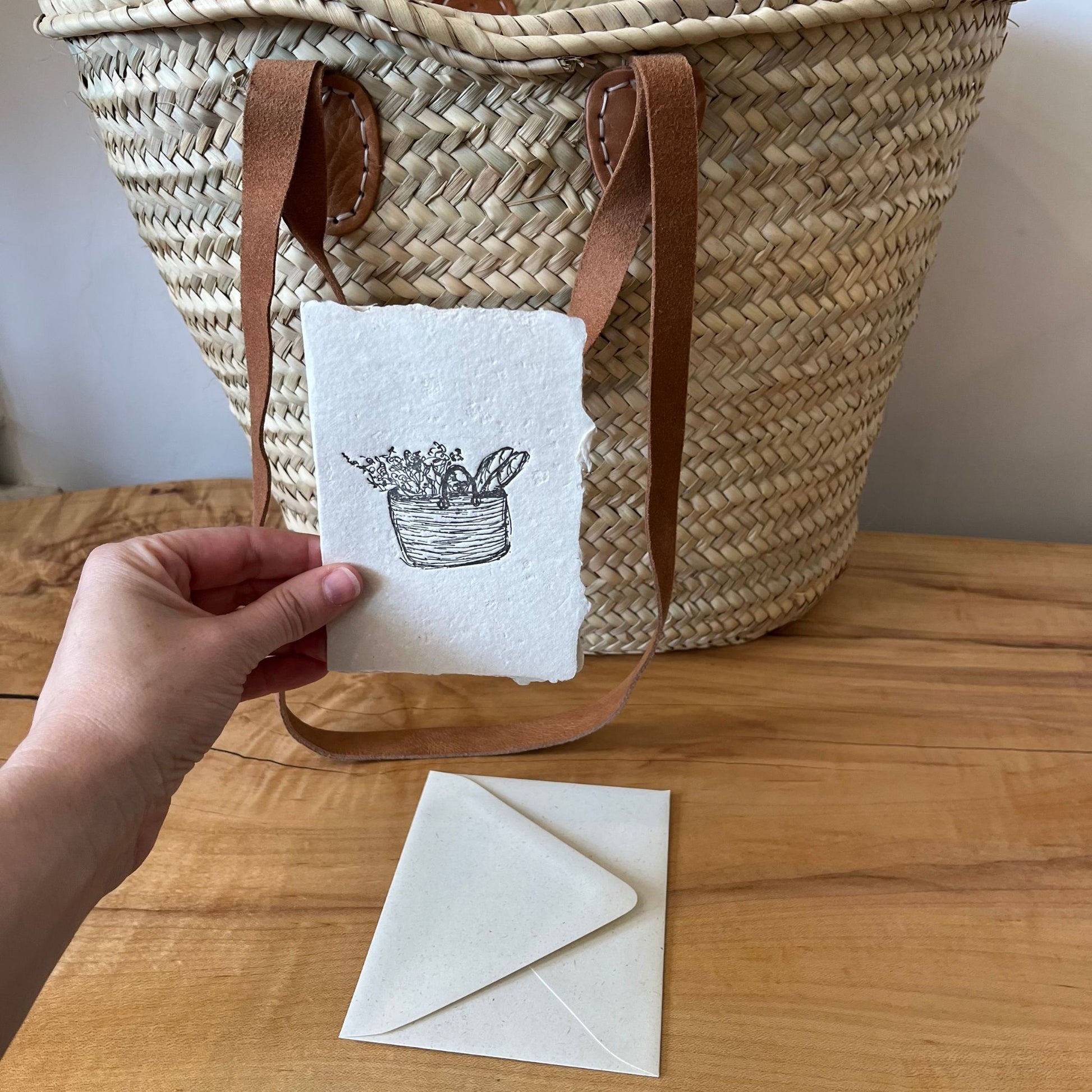 basket greeting card letterpressed on handmade paper with envelope in front of a basket
