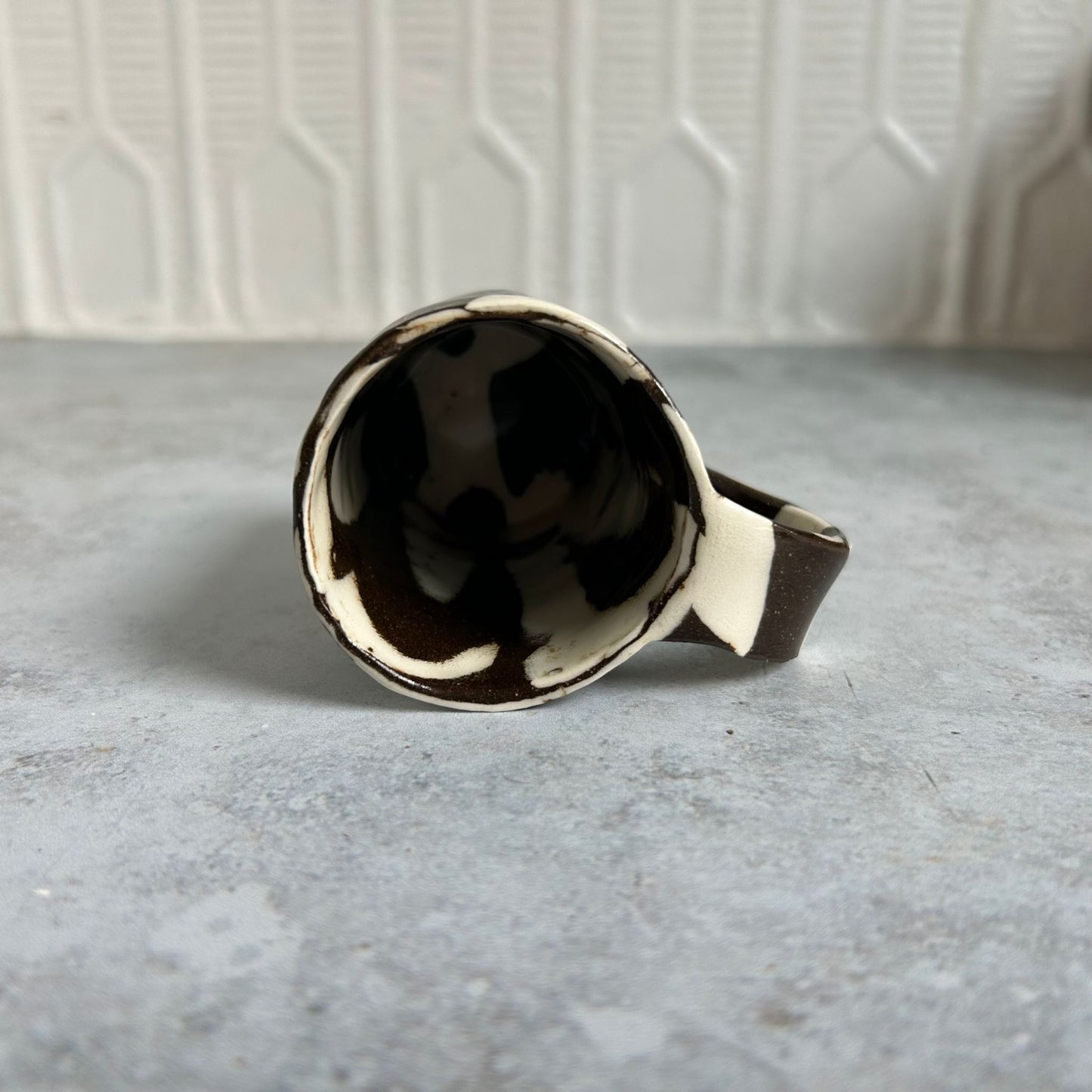 The inside of the brown and white espresso mug.