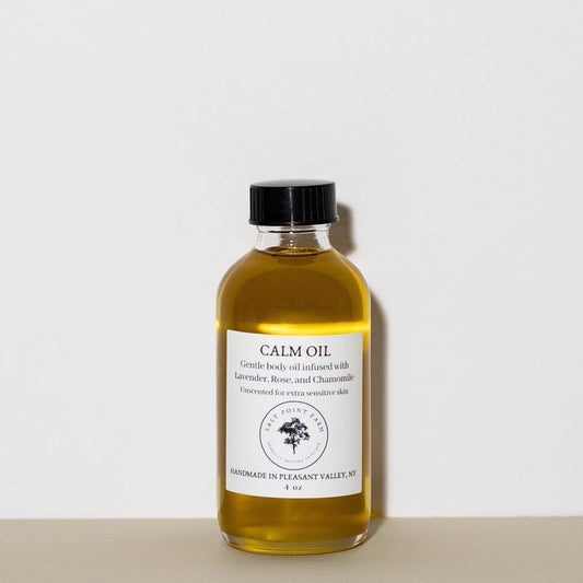 Calm Body Oil made from a blend of organic oils infused with Lavender and Chamomile flowers, Rose petals, and Sunflower-derived Vitamin E. Glass bottle filled with 4 Oz. of Body Oil
