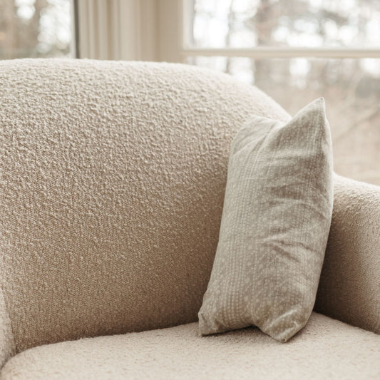 Buckwheat Pillow with dot print resting on a sofa. The cover is 100% linen.