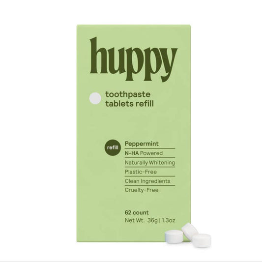 A green box with the "Huppy" logo and information about the tablets. Alongside the box is three tablets.