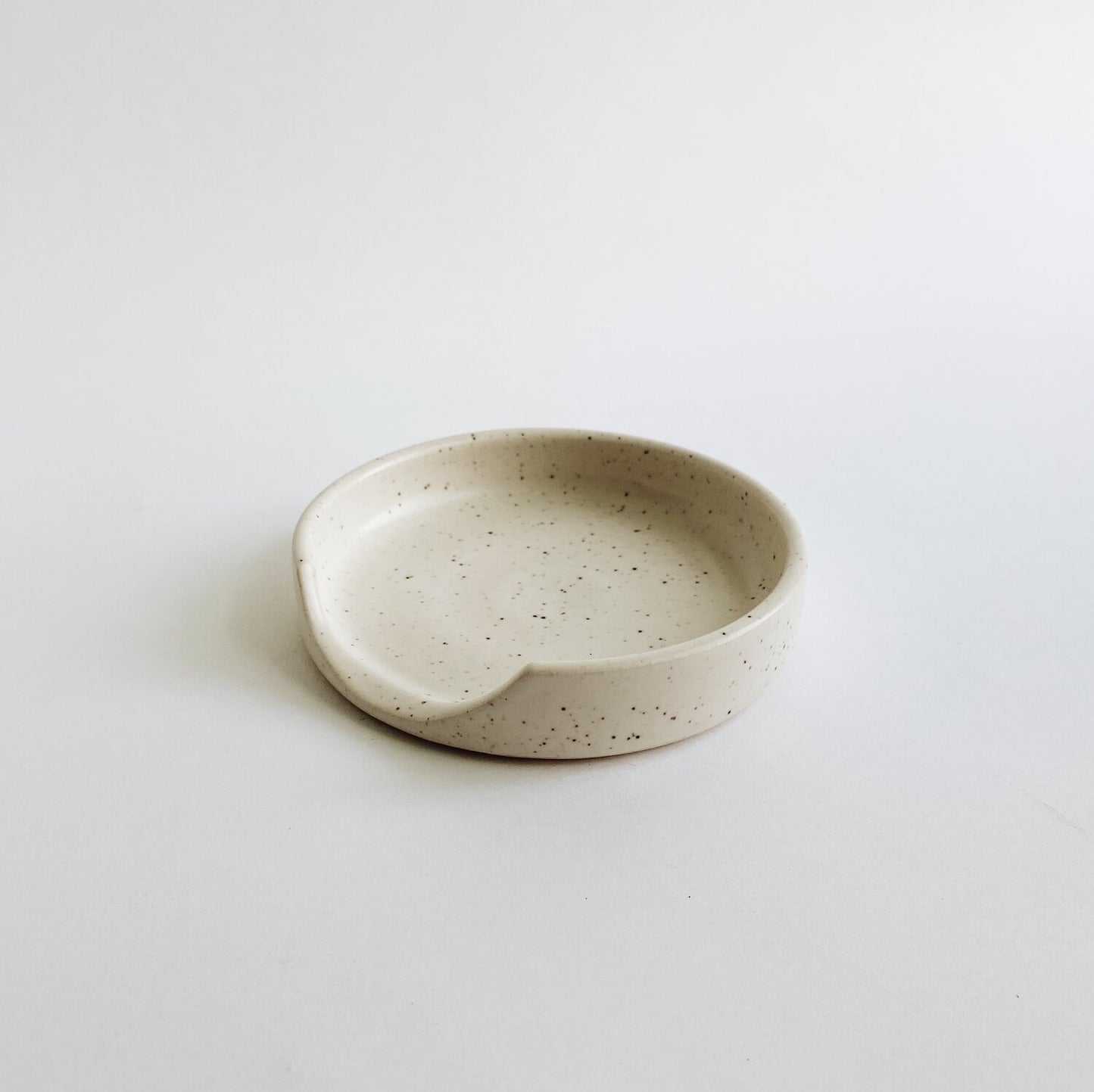 4.75 inch diameter ceramic stoneware spoon rest in white speckled glaze