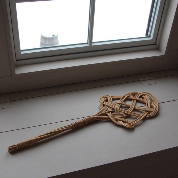 carpet beater on a wooden chest
