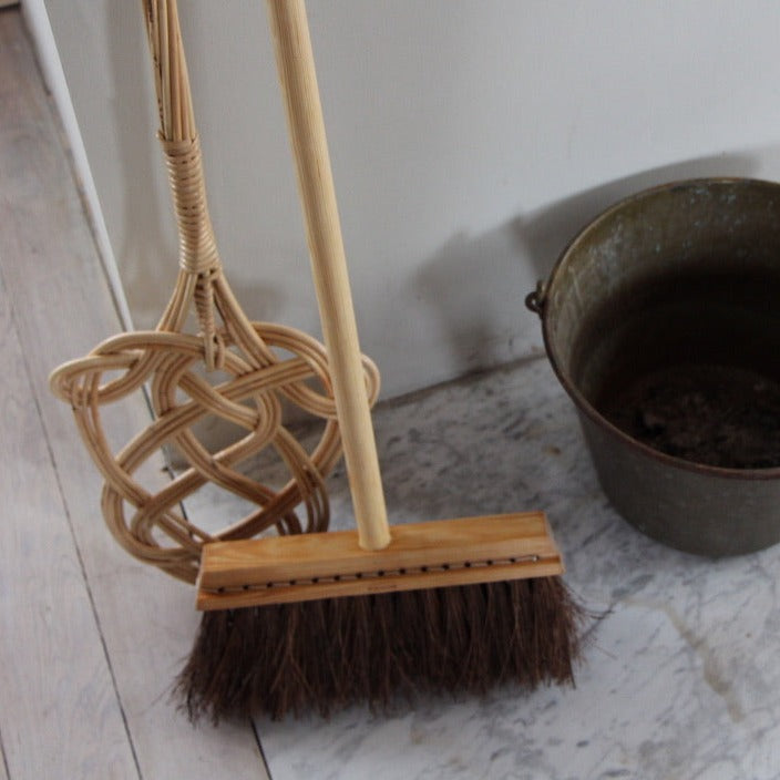 carpet beater with broom and metal bucket