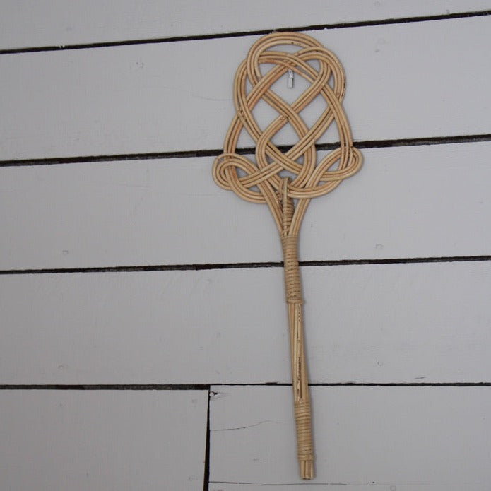 carpet beater hanging decoratively on a wall