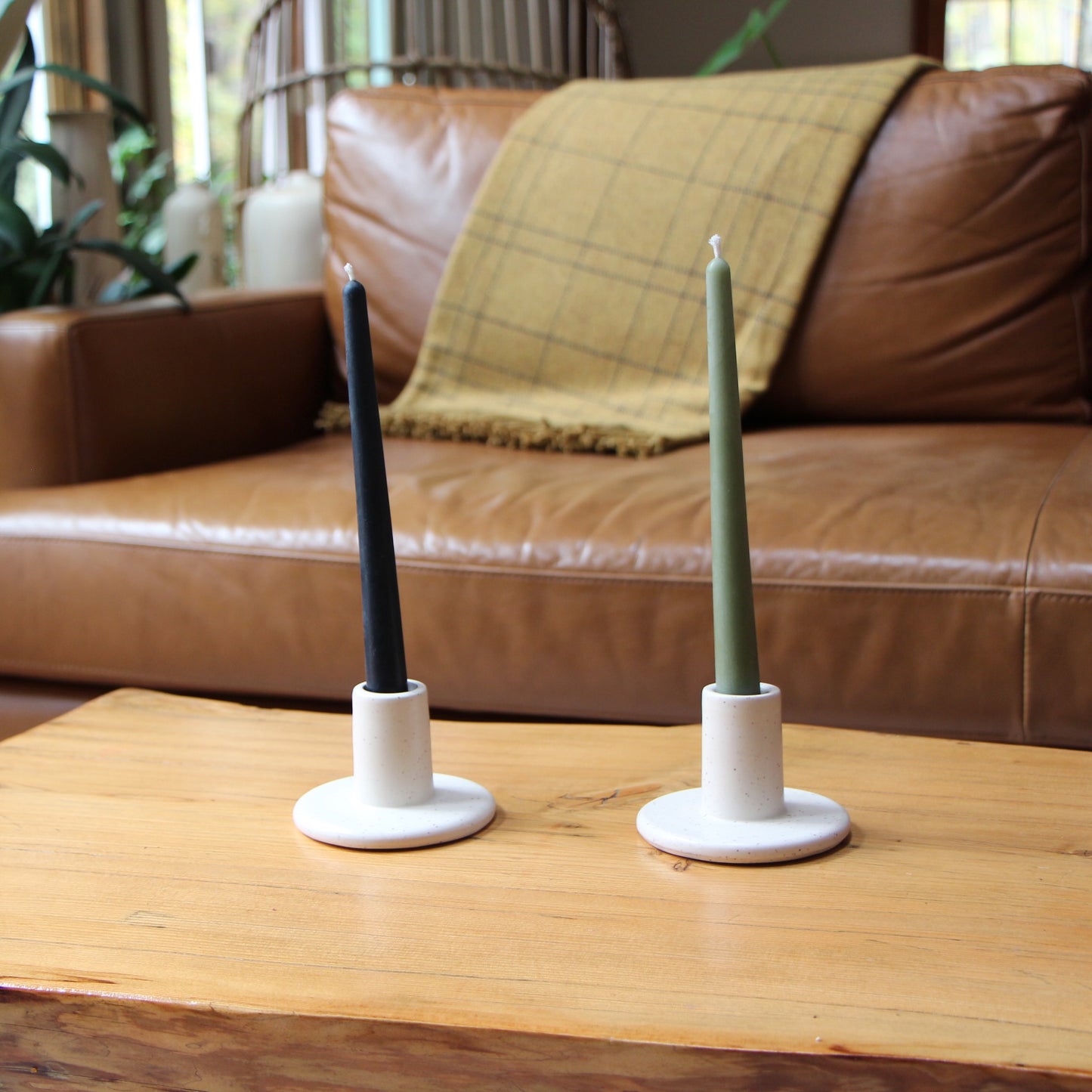 10-inch tall smooth taper candles shown set in ceramic candlesticks in a living room
