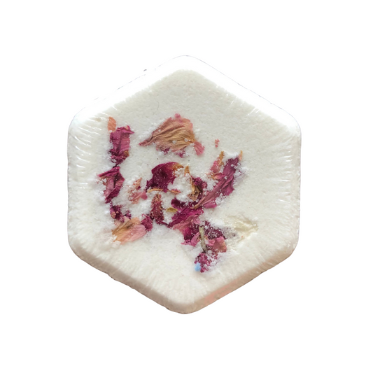 Bath bomb made of milk, honey, butters and pure essential oils of grapefruit, rose geranium and ylang ylang