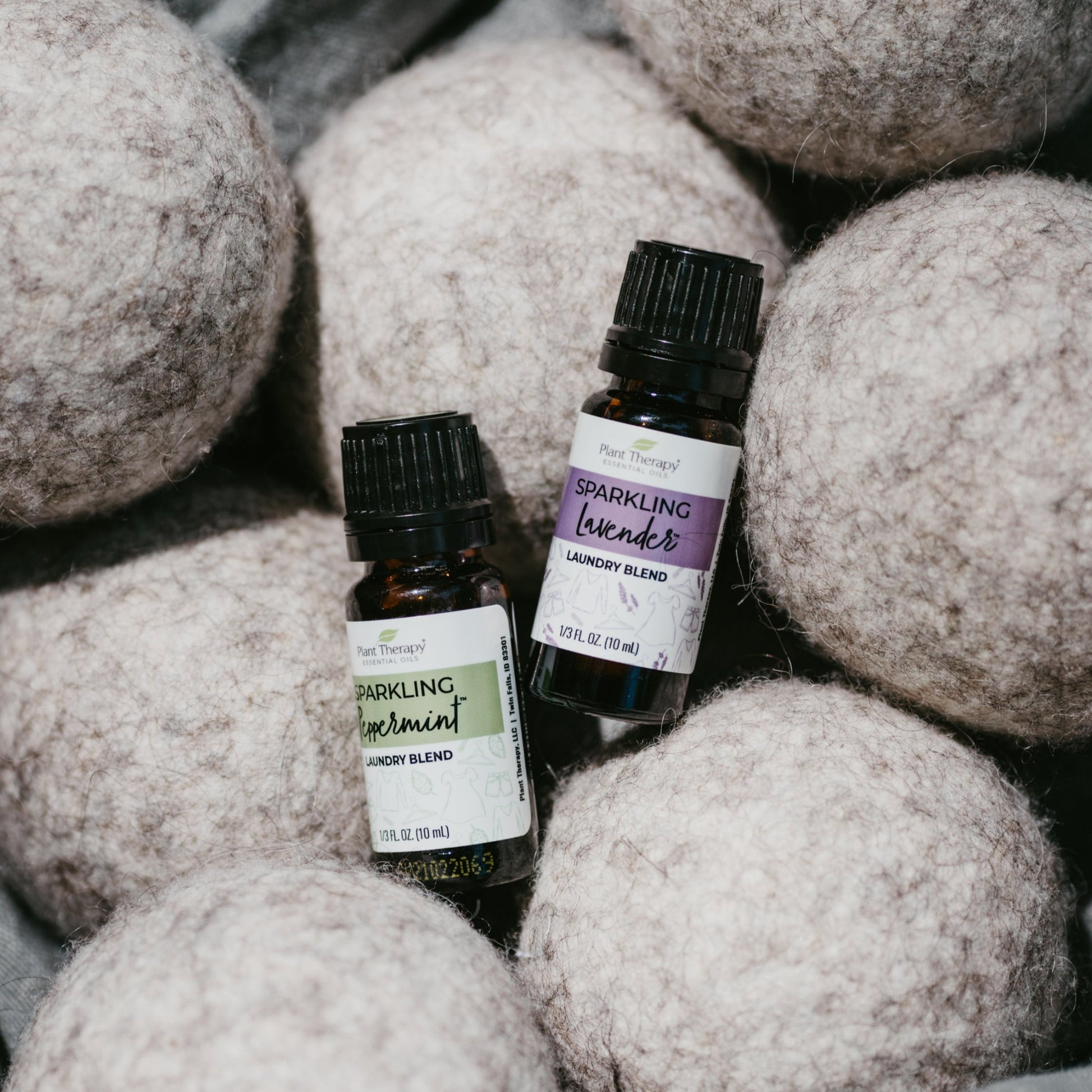 Peppermint essential oil for laundry shown with wool dryer balls