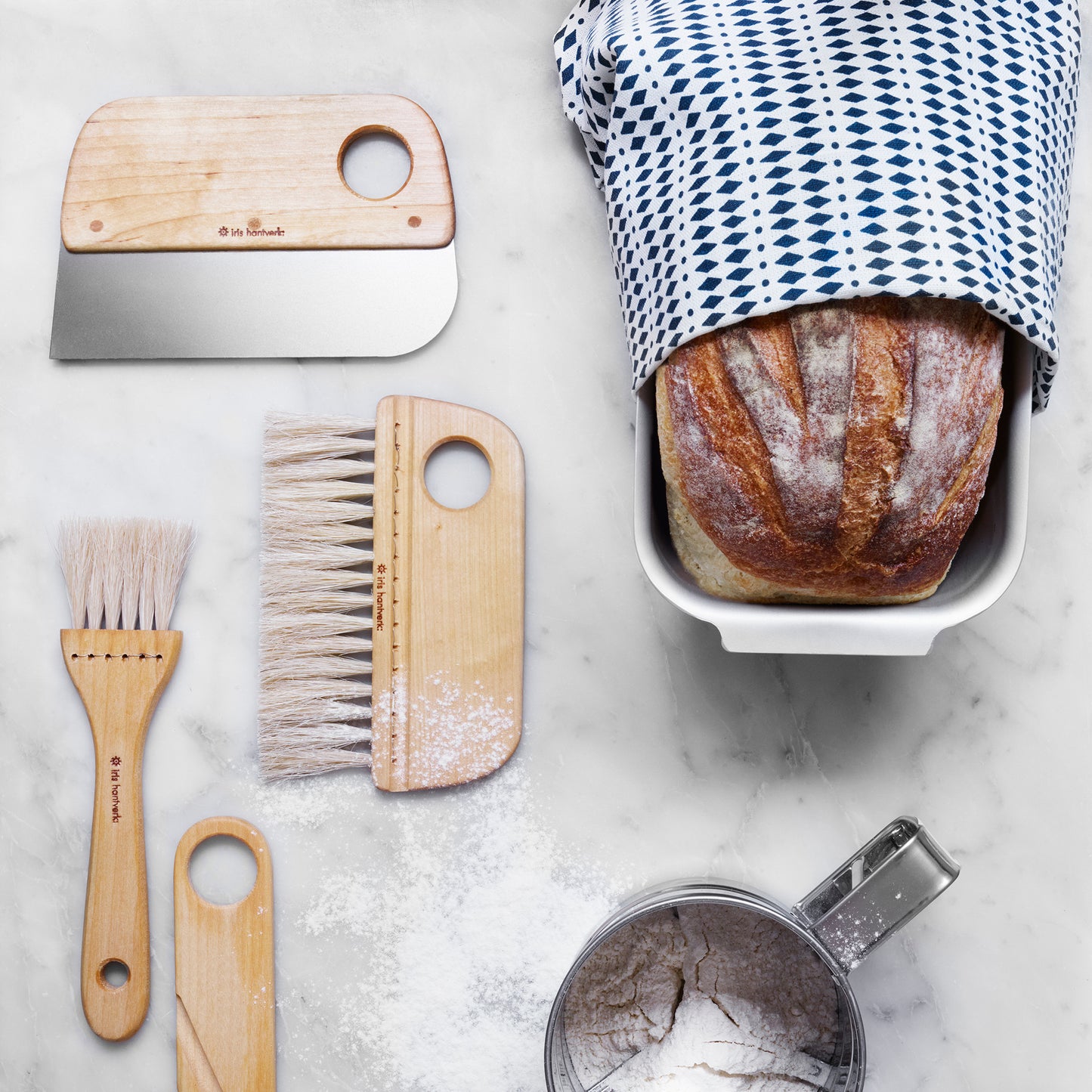 dough scraper with oil-treated birch handle and a strong stainless steel blade shown with matching pastry and bread making tools