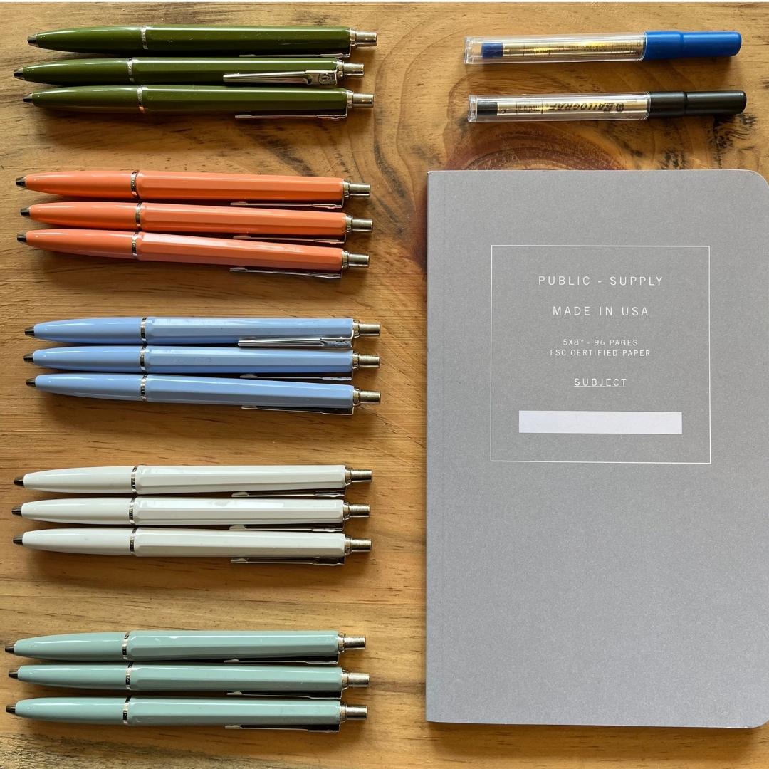 Ballograf refillable archival pens in various colors shown with ink refills, and a notebook