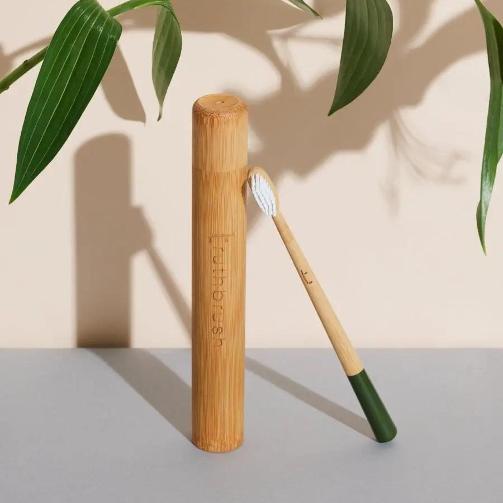 Bamboo toothbrush with Medium plant-based bristles in green with a Bamboo case