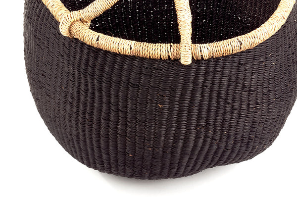 Close-up of handwoven Bolga basket in black color with leather handle