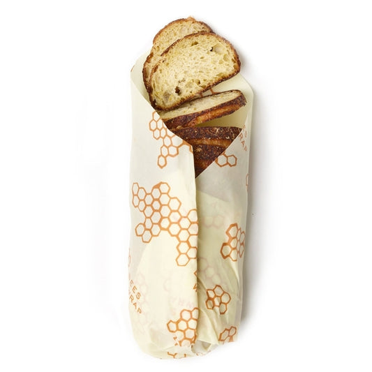 Cotton and beeswax alternative to plastic wrap shown covering a loaf of fresh bread