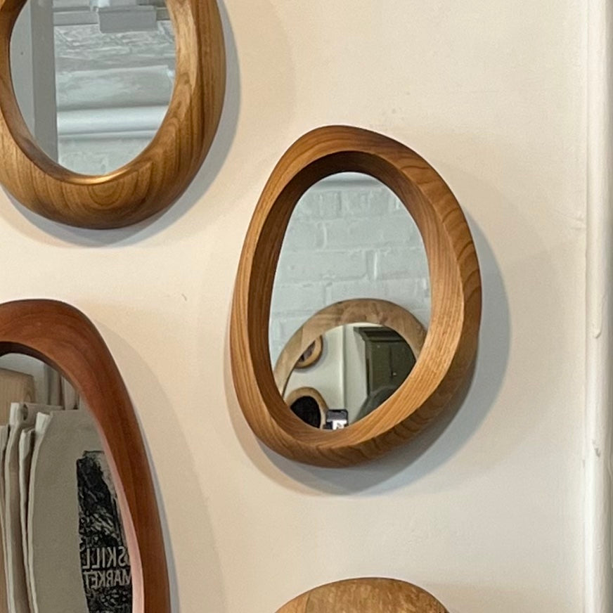 Small hand-carved butternut wood wall mirror with one-of-a-kind organic shape and curves