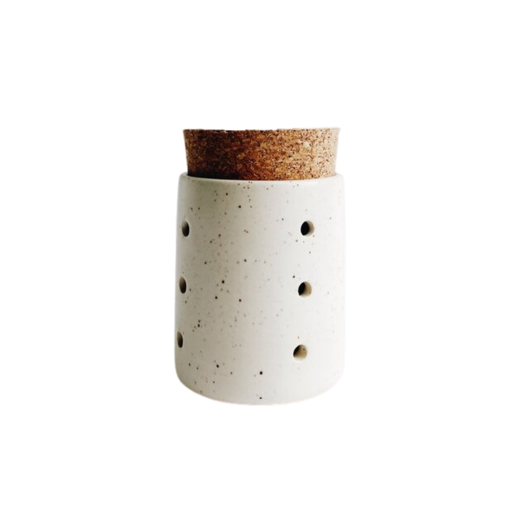 4 inch tall hand-thrown ceramic garlic jar in speckled white with holes for aeration and cork top