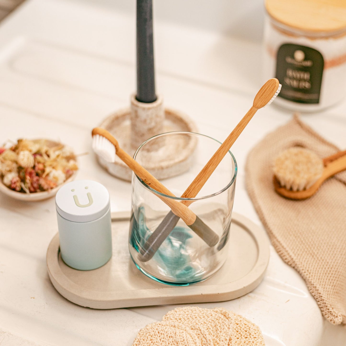 Concrete Oval Tray with some bath accessories (toothbrushes, dental floss and bath salts)