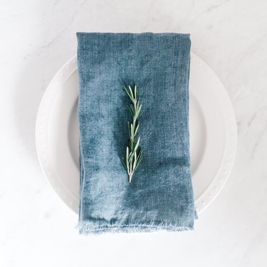 20-inch square stonewashed linen napkins with fringe edge shown in denim blue