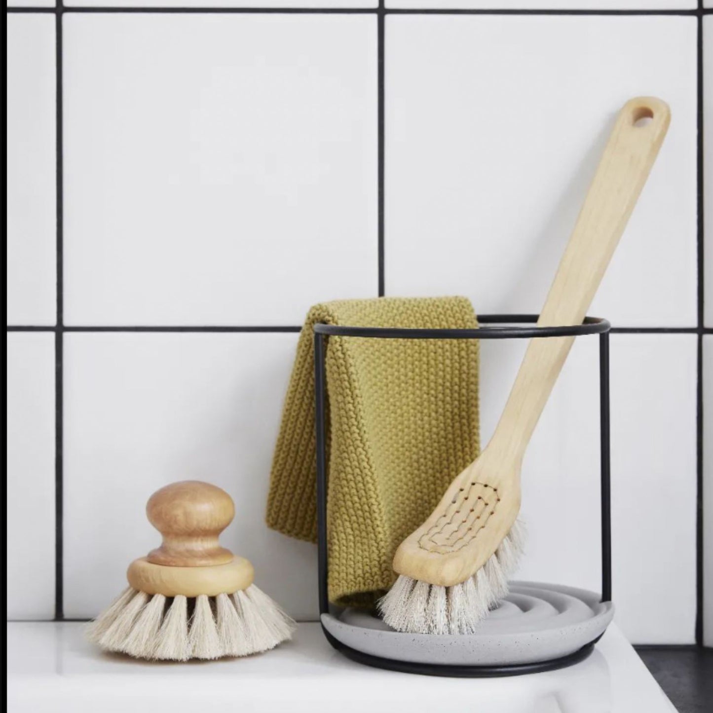 Metal and concrete stand for drying dish brushes. 