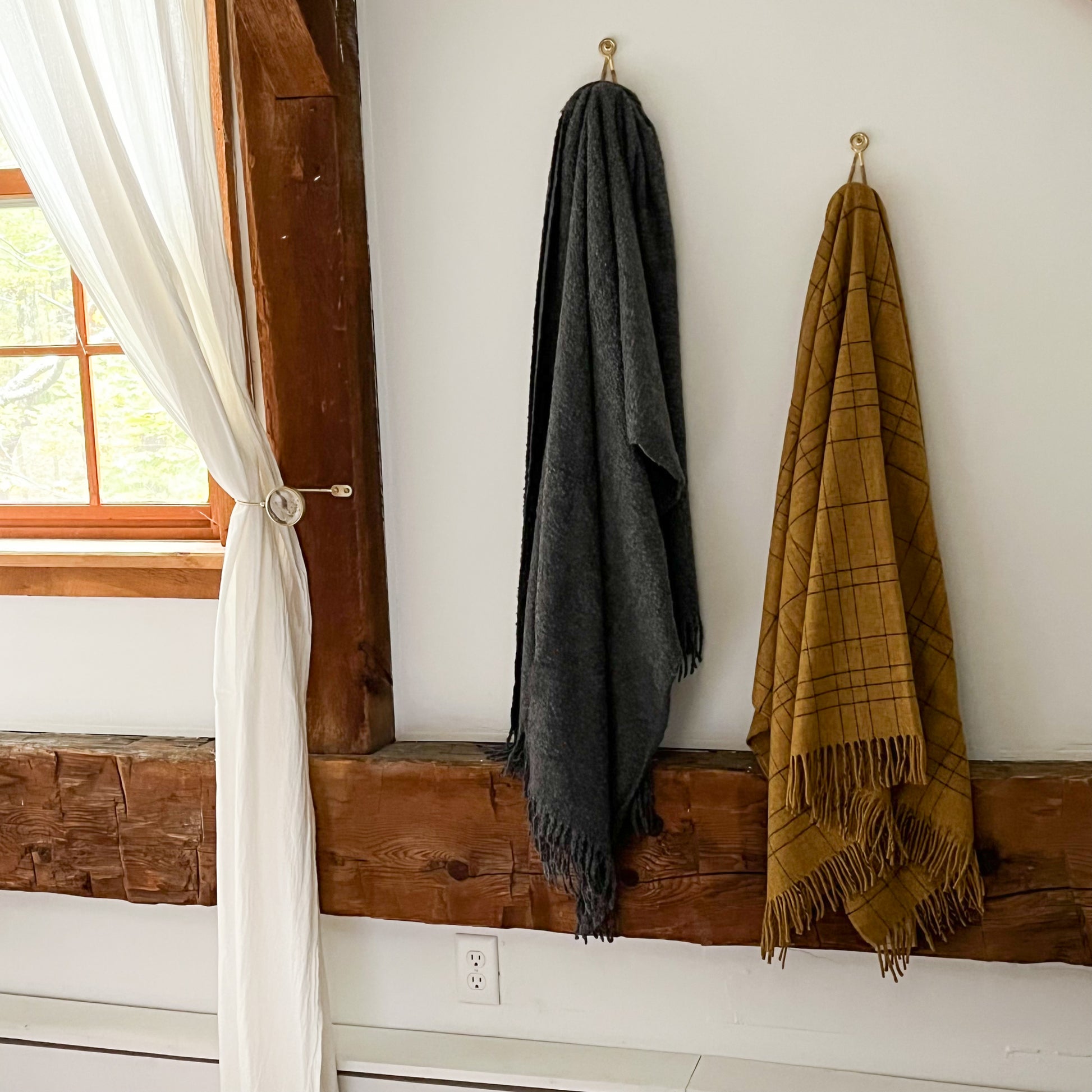 Cozy 100% Merino Lambswool throw blankets hanging on wall hooks