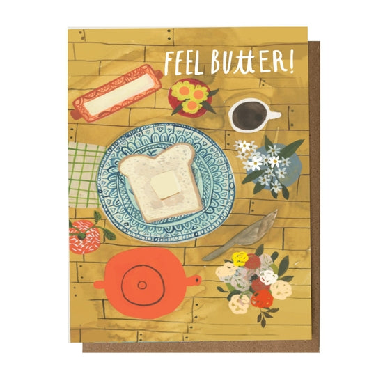 Folding card with illustration of wooden table with flowers, teapot, mug, and buttered toast with Feel Butter! written above